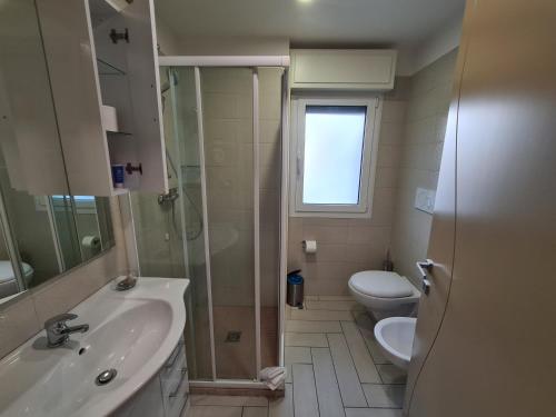 a bathroom with a sink and a toilet and a shower at Nero D'Avorio Apartments in Rimini