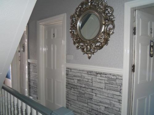 a stairway with a mirror on a wall at The Sefton Blackpool in Blackpool