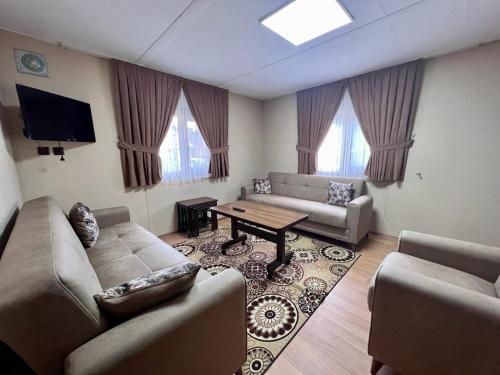 Kibar Home في أوزونغول: غرفة معيشة مع كنبتين وطاولة