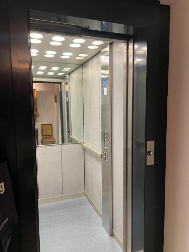 a hallway with a door leading to a dressing room at Grand T2 Plein centre historique avec ascenseur in Saint-Jean-de-Luz