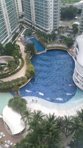 a large pool in the middle of a city with tall buildings at Holiday Escape Philippines in Manila