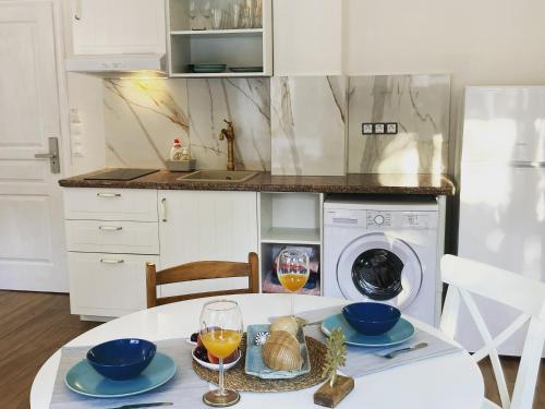 a kitchen with a table with a washing machine at Villa Ulyana Sarti - Ancient Greece in Center in Sarti