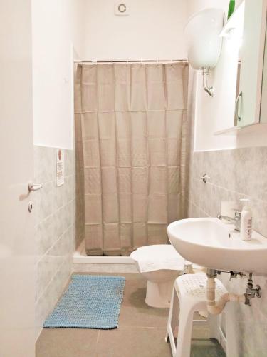 a bathroom with a sink and a toilet and a shower at Affitti brevi Olimpo Pompei in Pompei