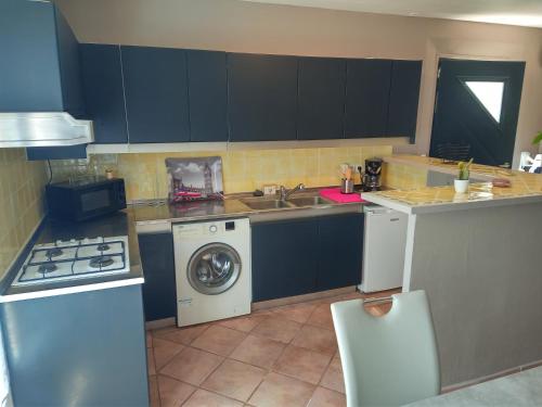 a kitchen with a sink and a washing machine at Emilie in Vidauban