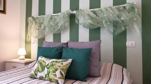 a bedroom with a bed with green and white stripes at Appartamento Vacanze a Manciano in Manciano