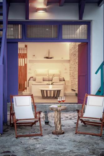 a living room with two chairs and a table at The Colourful Land Syrma in Klima