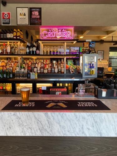 a bar with a drink on top of it at Illinois Hotel in Sydney
