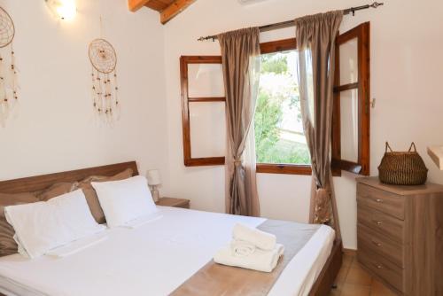 a bedroom with a bed and a window at F & B Summer Collection- Skiathos -Maistrali in Skiathos Town