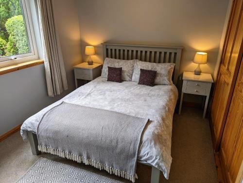 a bedroom with a large bed with two night stands at Holiday Accommodation Perth Scotland - Oakview in Perth