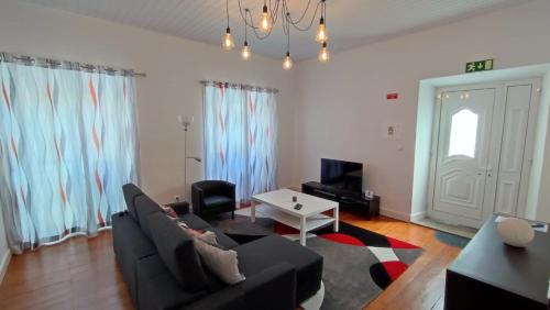 a living room with a couch and a table at Apartamento do Marquês in Santa Cruz das Flores