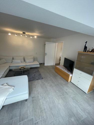 a room with a bed and a couch and a tv at Haus Annabell Diese Unterkunft steht Baufirmen nicht zur Verfügung in Bad Krozingen