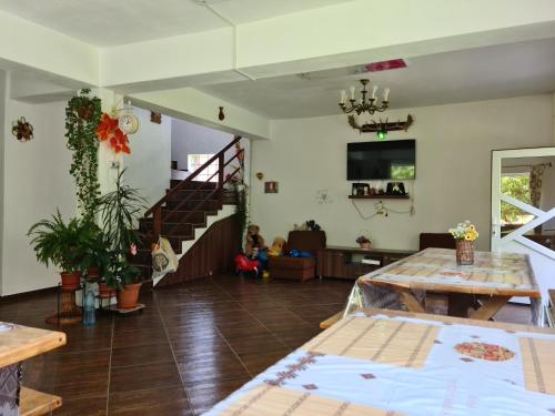 a living room with a table and a staircase at Pensiunea Constanta in Bran