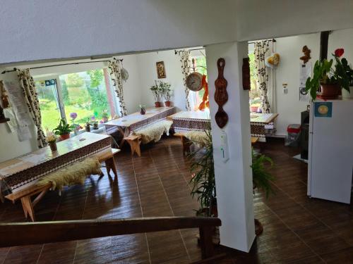 a living room with tables and chairs and a large window at Pensiunea Constanta in Bran