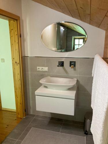 a bathroom with a sink and a mirror at Watzmann in Bischofswiesen