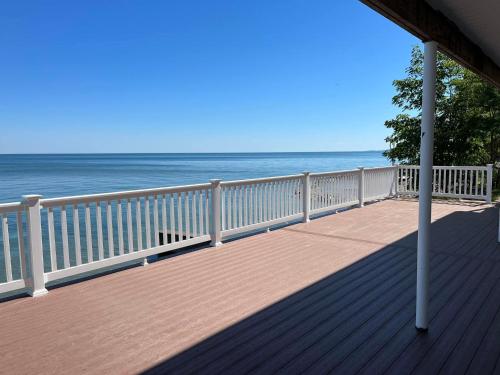 a wooden deck with the ocean in the background at Pete's Lakefront Motel, LLC in Geneva