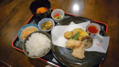a tray of food with rice and other foods at White Tree Log House Madarao Tangram in Shinano