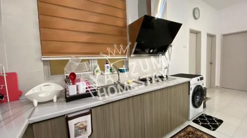 a kitchen with a washing machine and a microwave at Aya Izumi 3 bed Condo near to Bangi Wonderland in Kajang