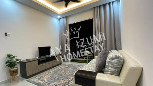 a living room with a couch and a tv at Aya Izumi 3 bed Condo near to Bangi Wonderland in Kajang