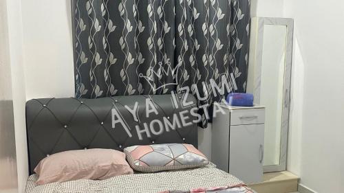 a bedroom with a black headboard and a mirror at Aya Izumi 3 bed Condo near to Bangi Wonderland in Kajang