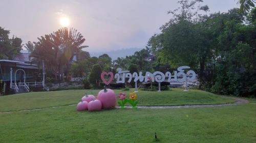 a park with easter decorations in the grass at Korp View House in Wang Nam Khieo
