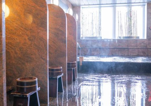 a row of stools in a room with water at Hotel New Palace in Shingu