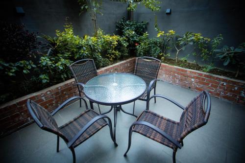 a table and four chairs sitting on a patio at The Elite Residence Dhaka in Dhaka