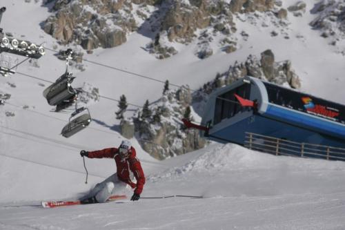 a person on skis in the snow next to a ski lift at Hotel Regglbergerhof in Nova Ponente