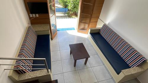 a staircase with a wooden table in a house at Pousada Ilha Vitoria in Ubatuba