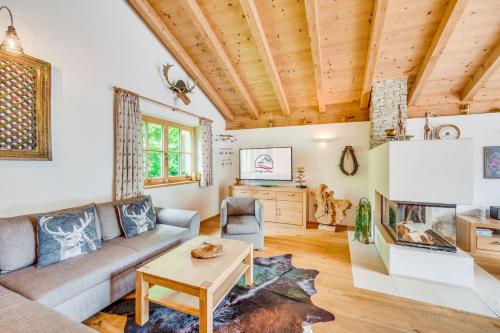 a living room with a couch and a fireplace at Chaletdorf am Sonnenhang in Neukirchen am Großvenediger
