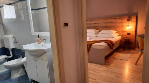 a bathroom with a bed and a sink in a room at Large apartment in Central Istria with private pool in Pulići
