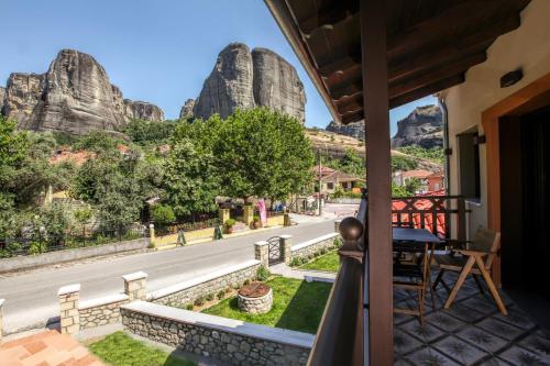 a balcony with a view of a road and rock formations at Meteora Heaven and Earth Kastraki premium suites - Adults Friendly in Kalabaka