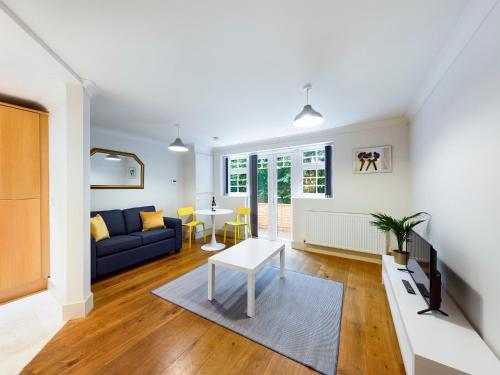 a living room with a couch and a table at Redhill town centre apartment by Livingo in Redhill