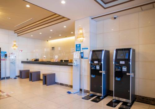 a lobby with a row of parking meters in a building at Hotel New Palace in Shingu