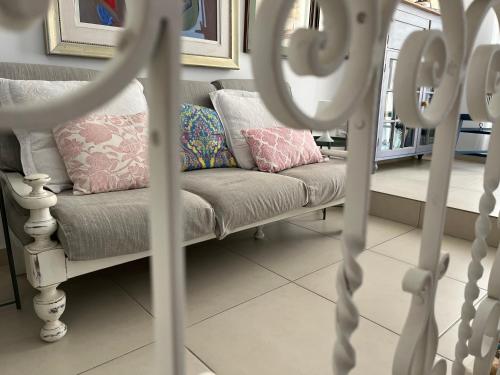 a couch with pillows on it in a living room at Little Blue House in Marsalforn