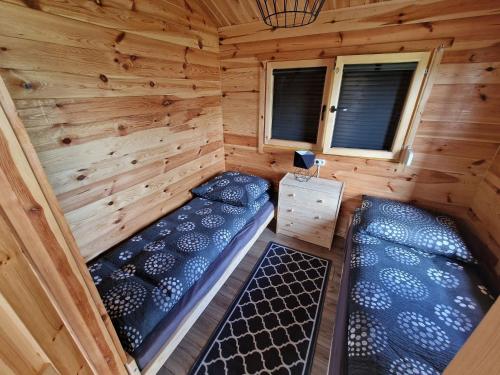 an aerial view of a log cabin with two beds at DOMKI POD DĘBEM in Grzybowo