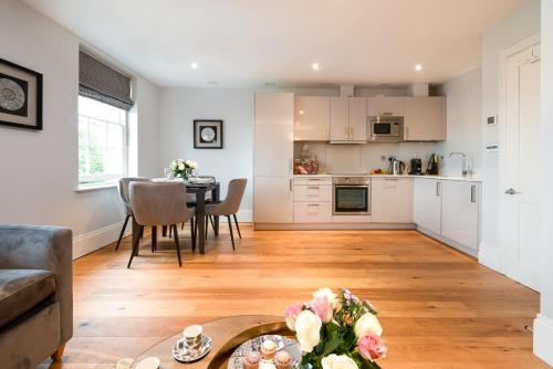 a kitchen and living room with a table and chairs at Bath Circle in Bath