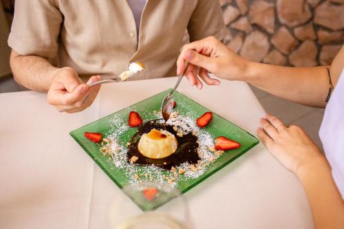 a group of people sitting at a table with a plate of food at New Bristol Sport Hotel in Cesenatico