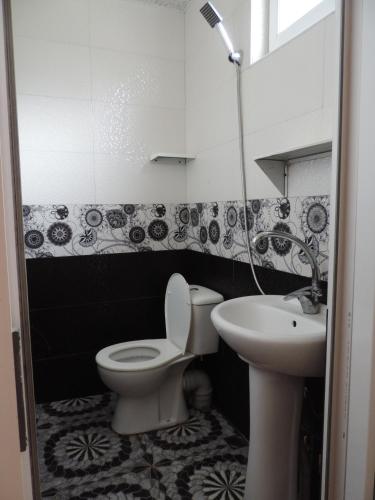 a bathroom with a toilet and a sink at LUKA in K'obulet'i