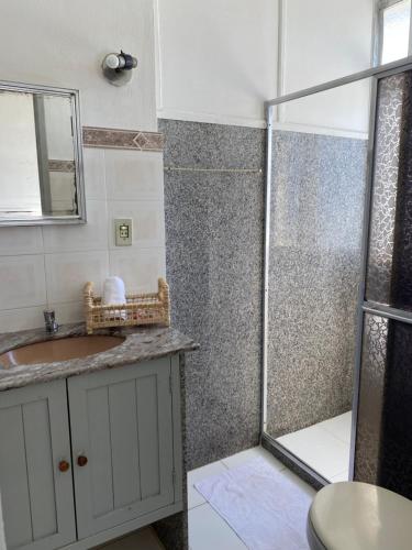 a bathroom with a shower and a sink at Casa Abel Hotel in Araruama