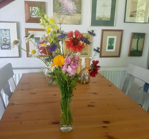 a vase of flowers sitting on a wooden table at Home on Iznik Lake with its own Private Beach in Bursa
