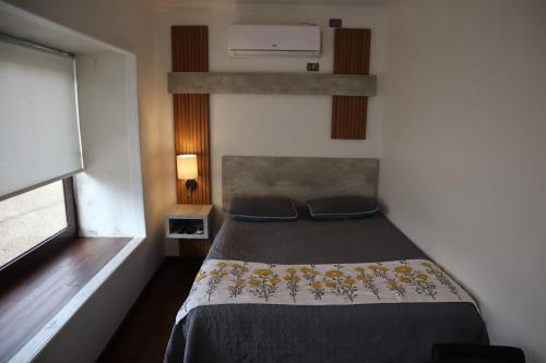 a bedroom with a bed and a window at Cabañas Habitainer BordeRio 2 in Concepción