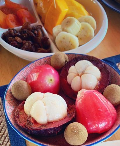 a bowl filled with fruits and vegetables on a table at La Maison - Chiangmai in Mae Taeng