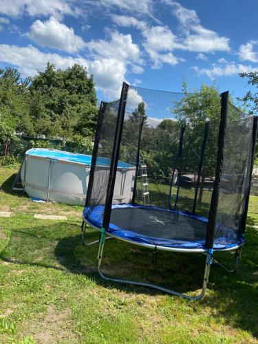 a trampoline in the grass next to a pool at Studio Ioana 2 in Râşnov
