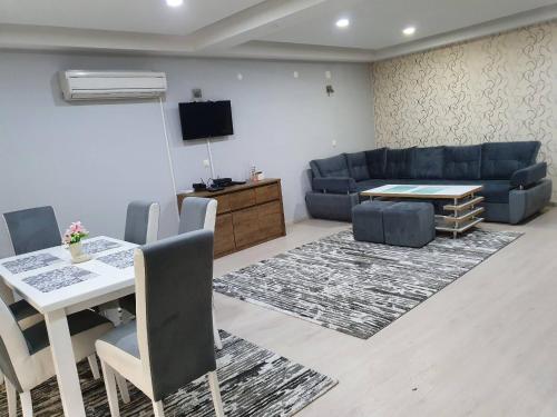 a living room with a table and a couch at Apartments Arna in Visoko