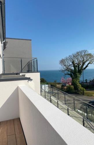 a balcony of a building with a view of the ocean at The Bay house Apartments , shanklin in Shanklin