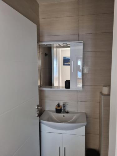 a bathroom with a sink and a mirror at Apartman Zlatan in Sveta Nedelja
