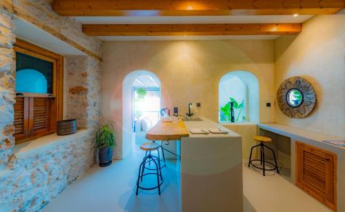 a kitchen with a counter and stools in a room at Churchill Townhouse in Bodrum City