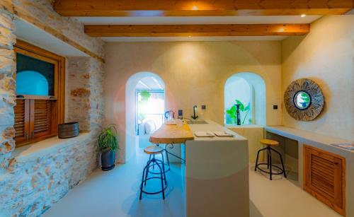 a kitchen with a counter and stools in a room at Townhouse in Bodrum City