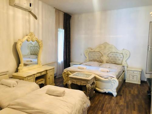 a bedroom with two beds and a mirror at Old Rabati in Akhaltsikhe