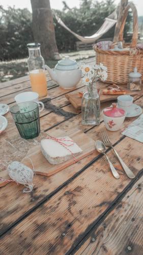 a wooden table with food and utensils on it at B&B La Buonora in Sinio